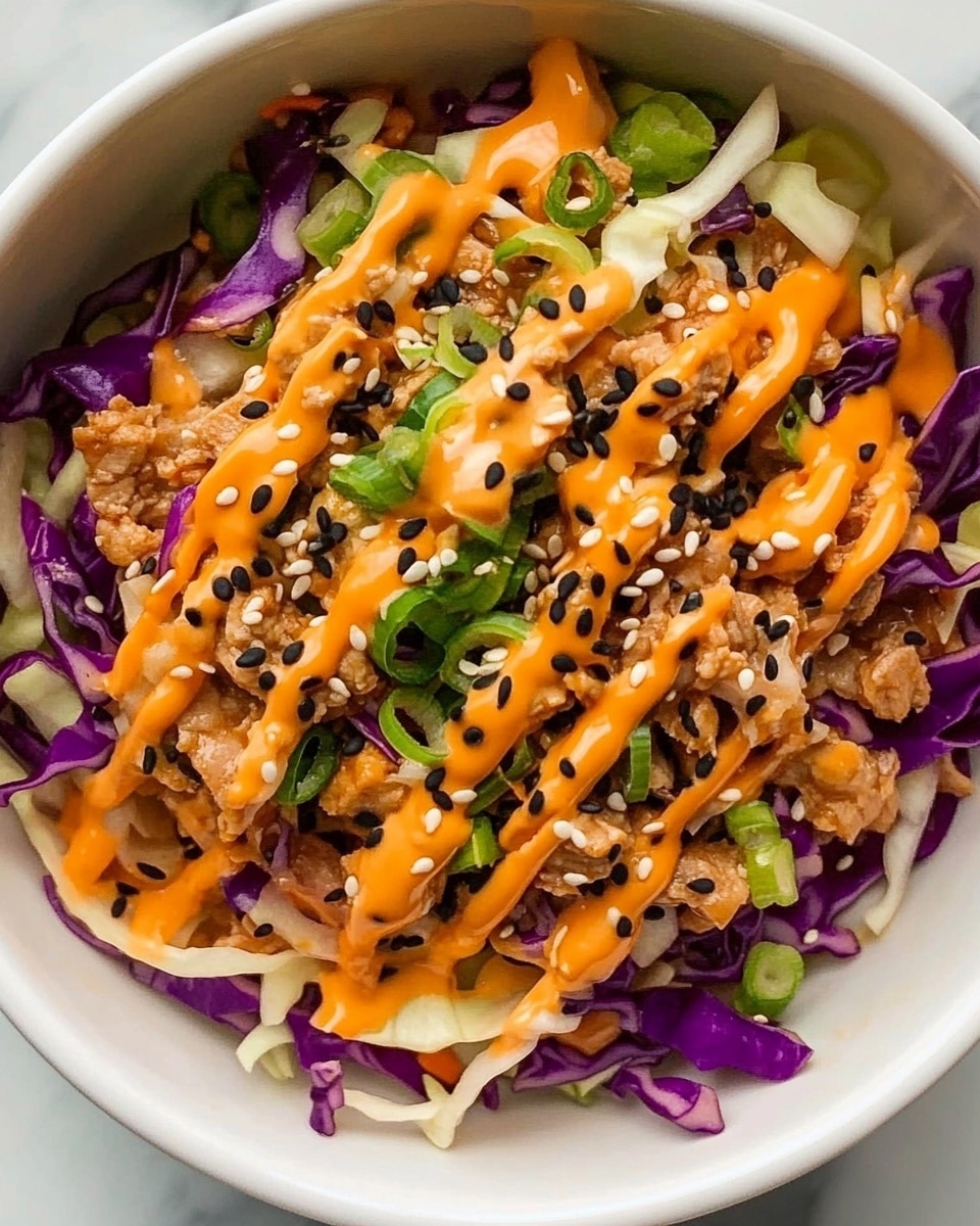 Inside a white bowl, there is a mixture of shredded purple and white cabbage forming the base layer, with some small pieces of light brown cooked meat spread evenly on top. Bright green sliced scallions are scattered across the dish, adding splashes of green. Orange-colored sauce is drizzled in wavy lines over the whole bowl, and small black sesame seeds are sprinkled on top to finish. The bowl is placed on a white marbled surface. photo taken with an iphone --ar 4:5 --v 6.1