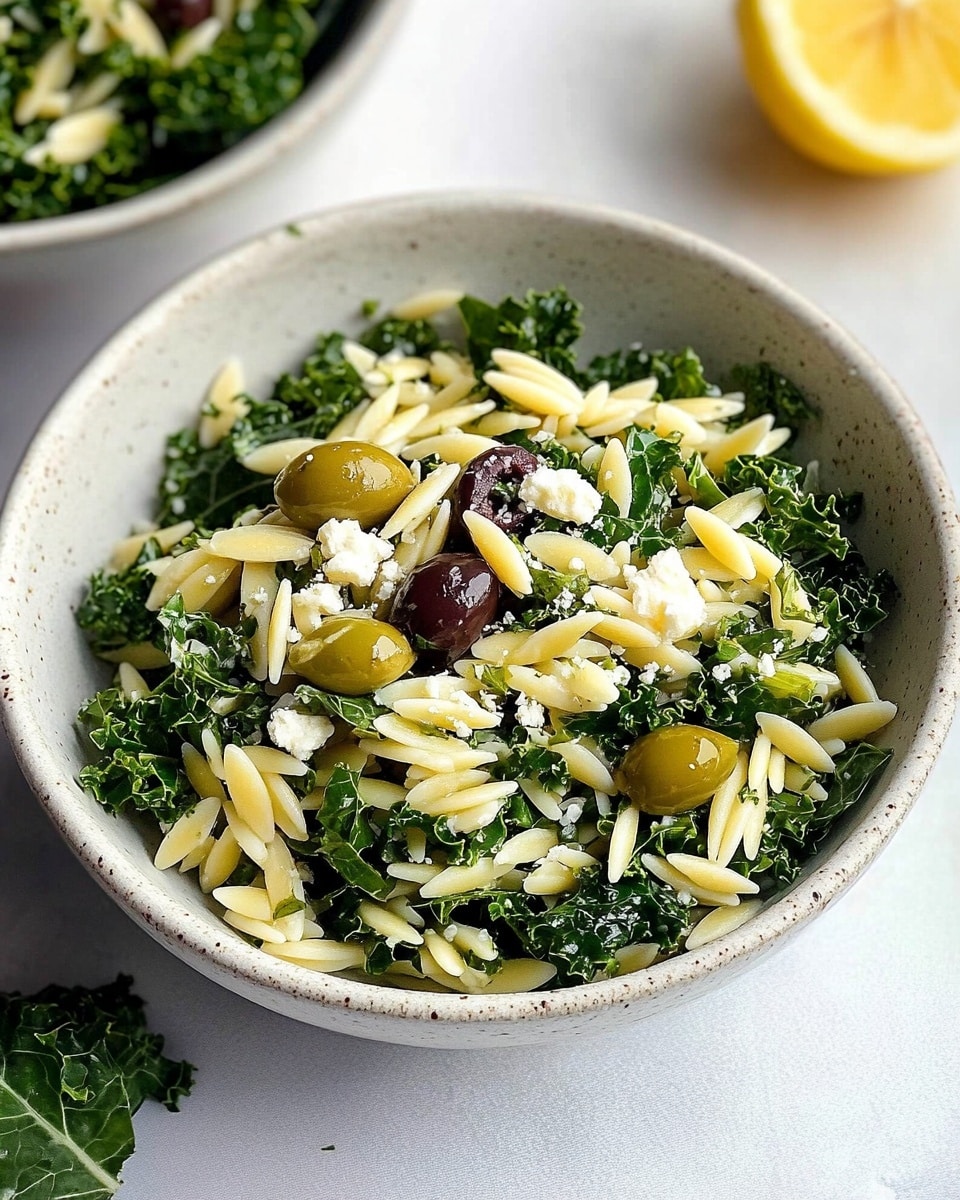 The image shows a wooden bowl filled with a mixed salad. The base layer is pale yellow orzo pasta, spread evenly throughout the bowl. On top of this are chopped dark green kale leaves, providing a leafy texture. There are dark purple olives scattered lightly among the leaves and pasta. Small green pumpkin seeds are spread across the salad, adding crunch. Thin, flat white cheese slices are scattered over the top, resting unevenly on the other ingredients. A wooden spoon is placed on the right side of the bowl, partially mixed in with the salad. The bowl sits on a white marbled surface. photo taken with an iphone --ar 4:5 --v 6.1