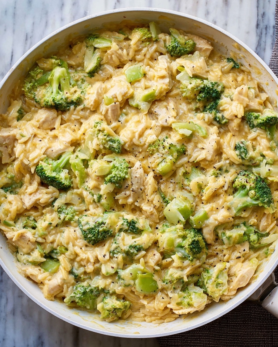 A close-up of a white bowl filled with a creamy dish made of three main layers: shredded light yellow cheese mixed evenly with small pieces of white rice as the base layer, bright green broccoli florets spread throughout as the second layer, and shredded light tan pieces of cooked chicken mixed in all over as the top layer. The texture looks soft and creamy with melted cheese coating all ingredients. Two silver spoons rest inside the bowl on the left side. The background shows a white marbled surface. Photo taken with an iphone --ar 4:5 --v 7