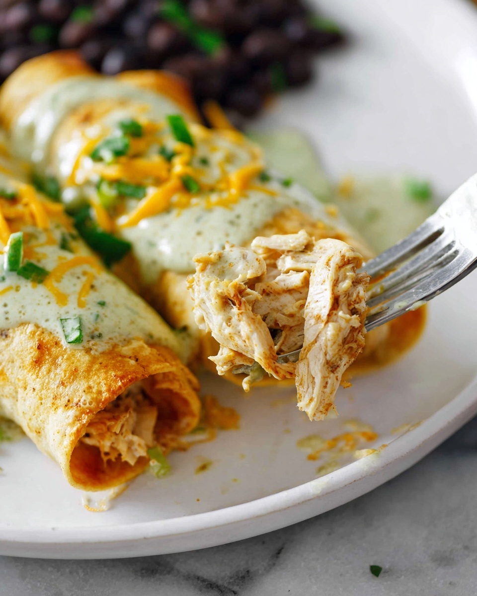 A white rectangular dish filled with rolled tortillas arranged in two rows, each tortilla covered with a thick orange sauce. On top of the sauce, there is a generous layer of shredded yellow and white cheese scattered evenly across all the tortillas. The tortillas appear soft and slightly browned under the sauce. The dish sits on a white marbled surface. photo taken with an iphone --ar 4:5 --v 7