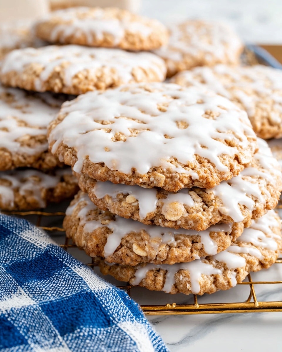 The image shows a group of round oatmeal cookies on a white marbled surface, each topped with a thin uneven layer of white icing that covers parts of the rough-textured golden-brown cookie. The cookies have irregular edges and some oats are visible on them as well as scattered around on the surface. The icing looks slightly glossy and has a random pattern on each cookie, giving a homemade appearance. Photo taken with an iphone --ar 4:5 --v 7
