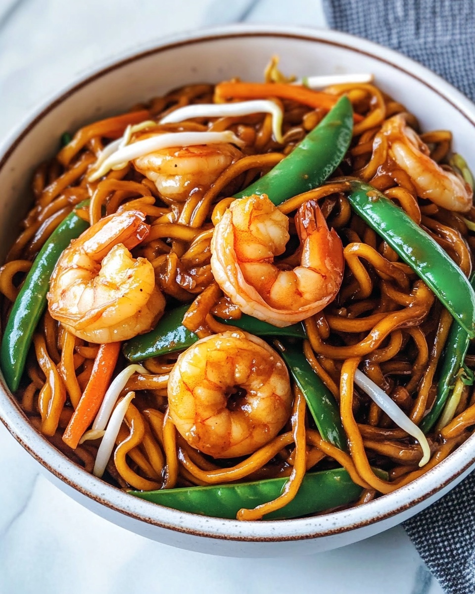 A white bowl filled with three large pinkish-orange cooked shrimp on top of a tangled bed of thick, brown stir-fried noodles mixed with green snap peas, white bean sprouts, and thin strips of orange carrot. The dish has a glossy, slightly oily texture. Two white chopsticks with blue patterns rest across the top edge of the bowl. The bowl sits on a table with a white marbled texture in the background. photo taken with an iphone --ar 4:5 --v 7