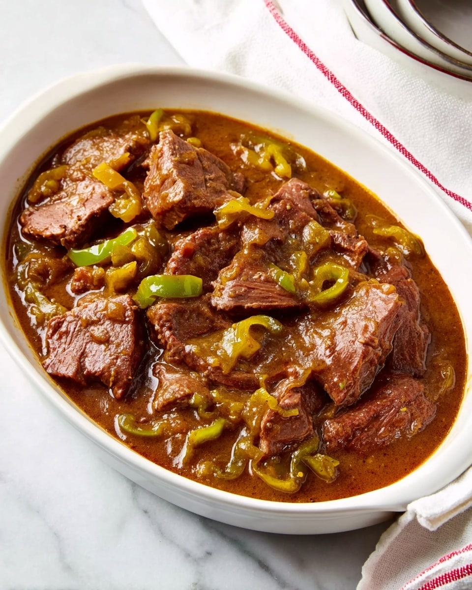 The image shows a white oval dish filled with chunks of brown meat in a thick brown sauce. There are pieces of light yellow and green peppers mixed in with the meat. The meat looks soft and tender with some visible fibers. The dish sits on a white marbled surface next to a white cloth with red stripes and a white bowl with a dark rim. The lighting is bright, making the sauce look shiny and fresh. photo taken with an iphone --ar 4:5 --v 7