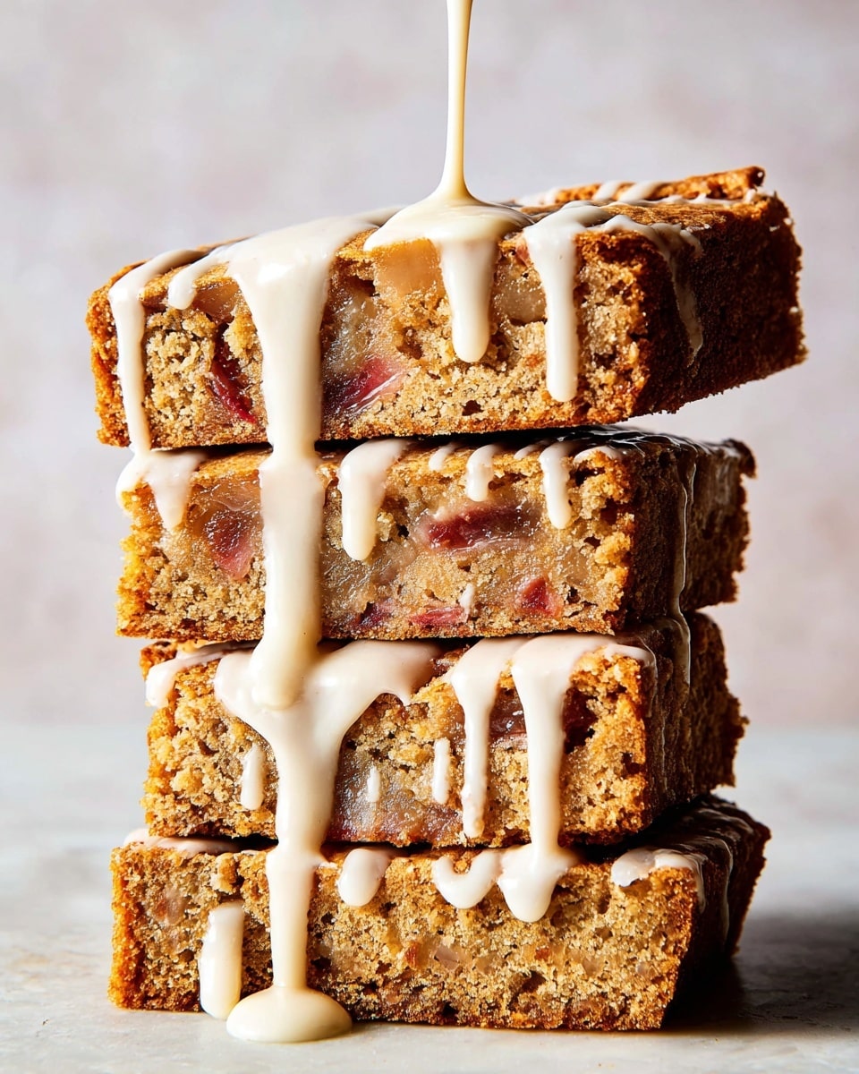 A rectangular baked dessert cut into 16 square pieces arranged neatly on a white marbled surface. Each piece has a golden brown, slightly textured top with visible cracks. A light white glaze is drizzled randomly over all the squares, creating thick and thin lines, some pooling slightly at the edges. The glaze stands out against the warm, crispy surface of the dessert, making it look fresh and inviting. Photo taken with an iphone --ar 4:5 --v 7