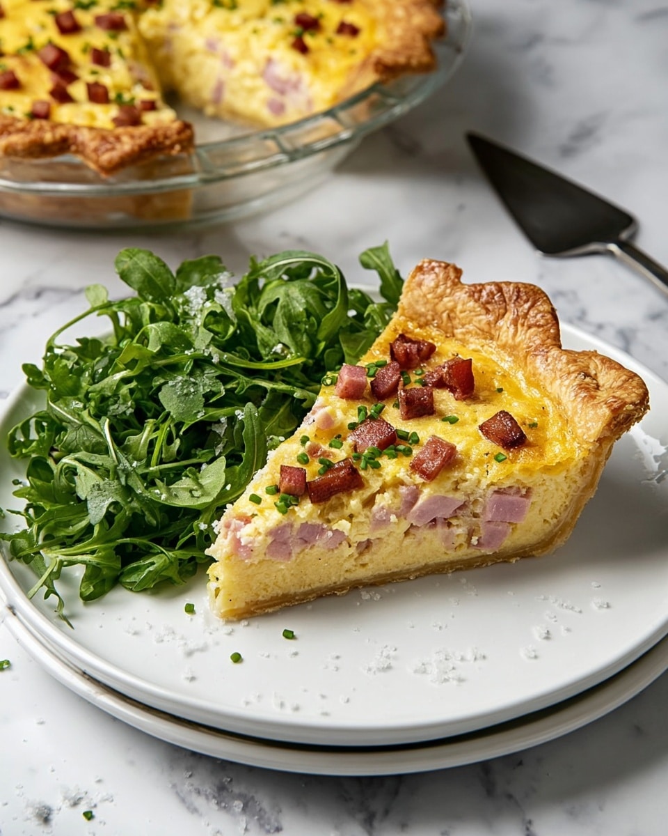 A golden pie with a thick, wavy crust sits on a clear round plate on a white marbled surface. The pie has a smooth yellow filling topped with small, browned cubes of meat and chopped green herbs scattered evenly on top. One slice is removed and placed next to the main pie, showing the even filling and crisp crust edge. A silver pie spatula lies beside the plate. Photo taken with an iphone --ar 4:5 --v 7