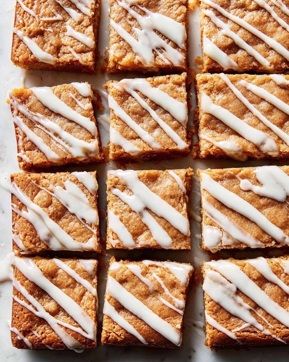 A stack of four thick rectangular blondie bars with a golden brown baked texture, each bar filled with visible chunks of light and dark fruit pieces inside. A light cream-colored sauce is pouring from the top onto the stack, slowly dripping down the sides in thick, smooth streams. The blondies have a crumbly yet moist look with some air pockets and a slightly rough surface. The background and surface are a white marbled texture. photo taken with an iphone --ar 4:5 --v 7
