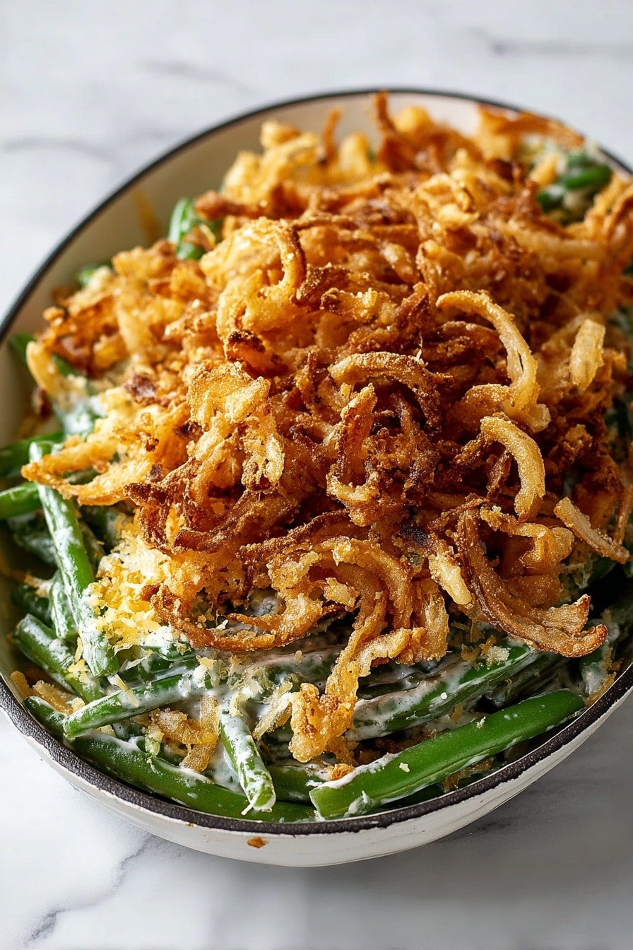 This is a three-layer green bean casserole served in a black rectangular pan with handles. The bottom layer shows bright green beans mixed with some mushrooms peeking through, forming a fresh green and dark brown base. On top of that, there is a sprinkling of a light beige crumbly or powdery topping, likely grated cheese or breadcrumbs, scattered unevenly over the beans. The top layer is a large pile of golden brown, crispy fried onion strings, giving a crunchy texture and covering most of the dish. The pan is placed on a white marbled surface with some loose crumbs scattered around, and a beige cloth is at the top left corner of the image. photo taken with an iphone --ar 2:3 --v 7 - Green Bean Casserole with French Fried Onions, homemade green bean casserole, crispy onion green bean bake, holiday green bean casserole, easy green bean casserole