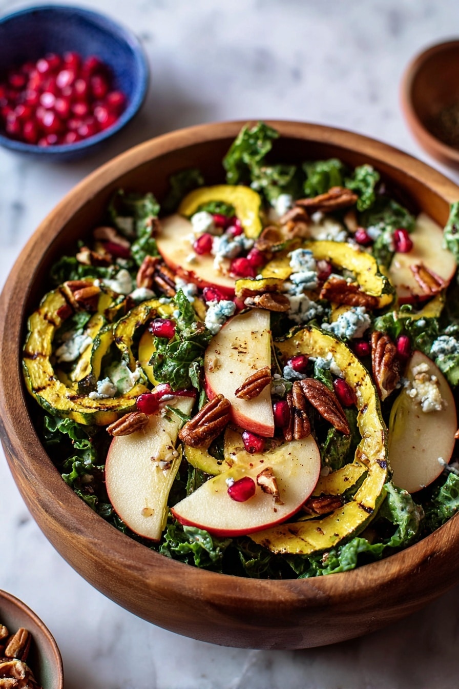 A wooden bowl filled with a colorful salad standing on a white marbled surface. The bottom layer is made of green leafy kale and spinach. On top, there are thin, light yellow rings of grilled squash with light brown grill marks and thin slices of pale cream apple with red edges and apple cores visible. Scattered across are small, shiny, bright red pomegranate seeds and small brown pecan pieces. Light blue crumbles of cheese are sprinkled over everything, giving a soft texture contrast. Photo taken with an iphone --ar 2:3 --v 7 - Thanksgiving Kale Salad with Cranberry Cinnamon Vinaigrette, holiday kale salad, festive fall salad recipe, healthier Thanksgiving side dish, cranberry cinnamon vinaigrette
