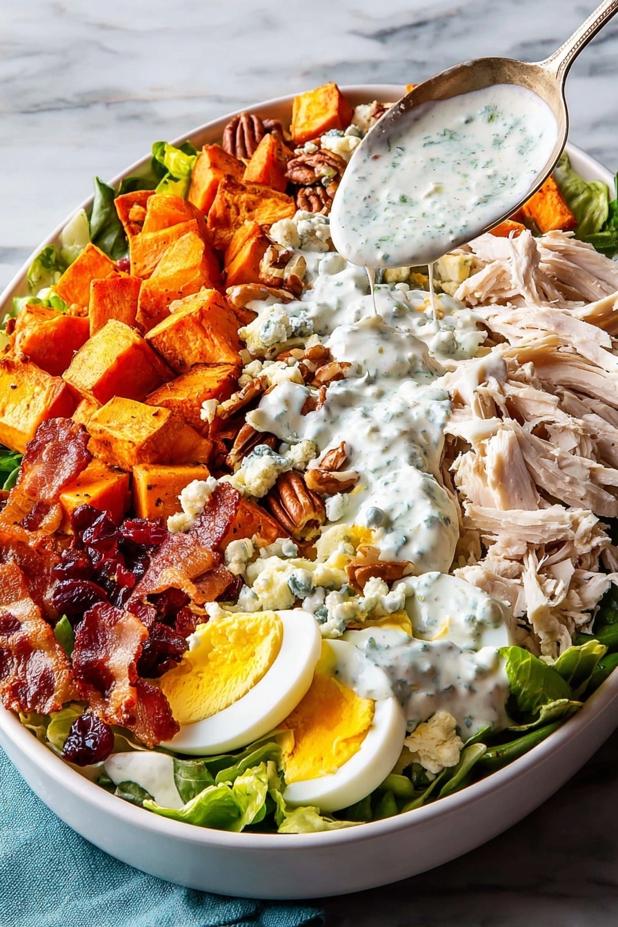 Two white bowls filled with fresh salad sit on a white marbled surface. Each bowl holds a base of bright green lettuce leaves. On top, there are slices of light brown chicken, dark brown pecan nuts, chunks of orange sweet potato, and pieces of yellow and white boiled egg. Scattered around are small bits of blue cheese and dark red dried cranberries. White creamy dressing is drizzled over the salad. A spoon rests inside a small white bowl with more creamy dressing to the side. The bowls show a mix of soft, crunchy, and creamy textures in a colorful composition. Photo taken with an iphone --ar 2:3 --v 7 - Thanksgiving Cobb Salad, Thanksgiving Cobb Salad Recipe, holiday salad ideas, festive Thanksgiving salads, easy holiday salad