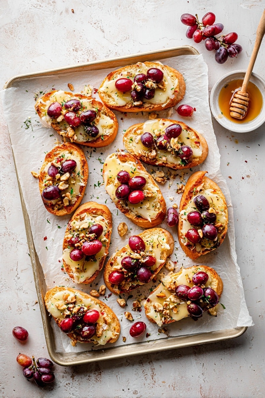 The image shows slices of toasted bread arranged on a baking tray lined with parchment paper, each slice topped with three layers: a bottom layer of golden brown toasted bread, a middle layer of creamy, melted cheese with a soft smooth texture, and a top layer of shiny red cherries mixed with small pieces of crushed nuts scattered over them. A small white bowl filled with honey with a wooden honey dipper resting inside is placed next to the bread slices on the tray. The background surface is a white marbled texture. Photo taken with an iphone --ar 2:3 --v 7 - Roasted Grape & Brie Crostini with Honey and Sea Salt, roasted grape crostini, brie appetizer, honey and sea salt crostini, elegant grape crostini