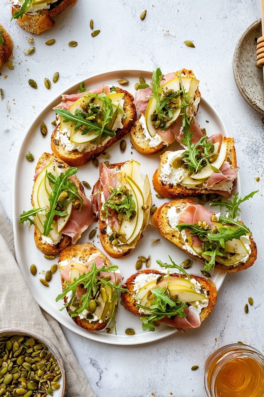 The image shows several pieces of toasted bread slices with a golden-brown crust and a soft, airy inside. Each slice is layered with a spread of creamy white cheese, topped with thin, translucent slices of cured meat. On top of the meat, there are thin slices of light yellow pear with green edges, sprinkled with green roasted pumpkin seeds and small green arugula leaves. The toasts are placed on a light grey plate, which is set on a white marbled surface. Photo taken with an iphone --ar 2:3 --v 7 - Ricotta and Pear Crostini with Salty Pumpkin Seed Pistachio Crunch, pear crostini with ricotta, gourmet appetizer with pear and nut crunch, easy pear and ricotta crostini, sophisticated appetizer for entertaining