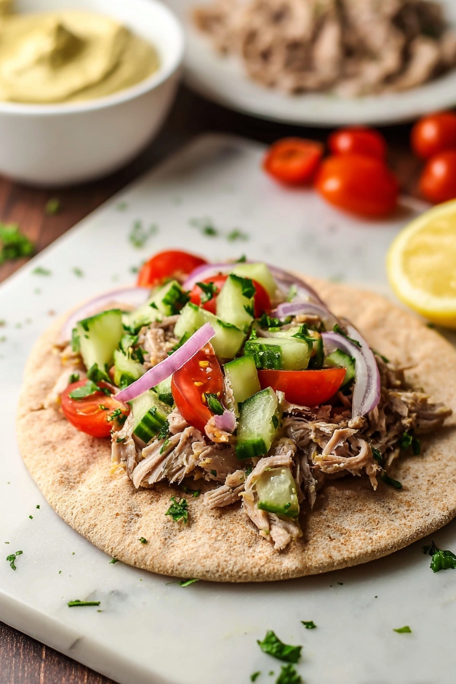A flat, round whole wheat pita bread lies open on a white marbled surface, with a layer of shredded light brown meat spread evenly in the center. On top of the meat are slices of red tomato, chunks of green cucumber, thin rings of light purple onion, and sprinkles of fresh green herbs. In the background, a white bowl with a creamy, light yellow mustard-colored sauce sits out of focus, with another white plate of more shredded meat and some red cherry tomatoes scattered further behind. The photo taken with an iphone --ar 2:3 --v 7 - Slow Cooker Chicken Shawarma, chicken shawarma, easy shawarma recipe, homemade shawarma, flavorful chicken recipes