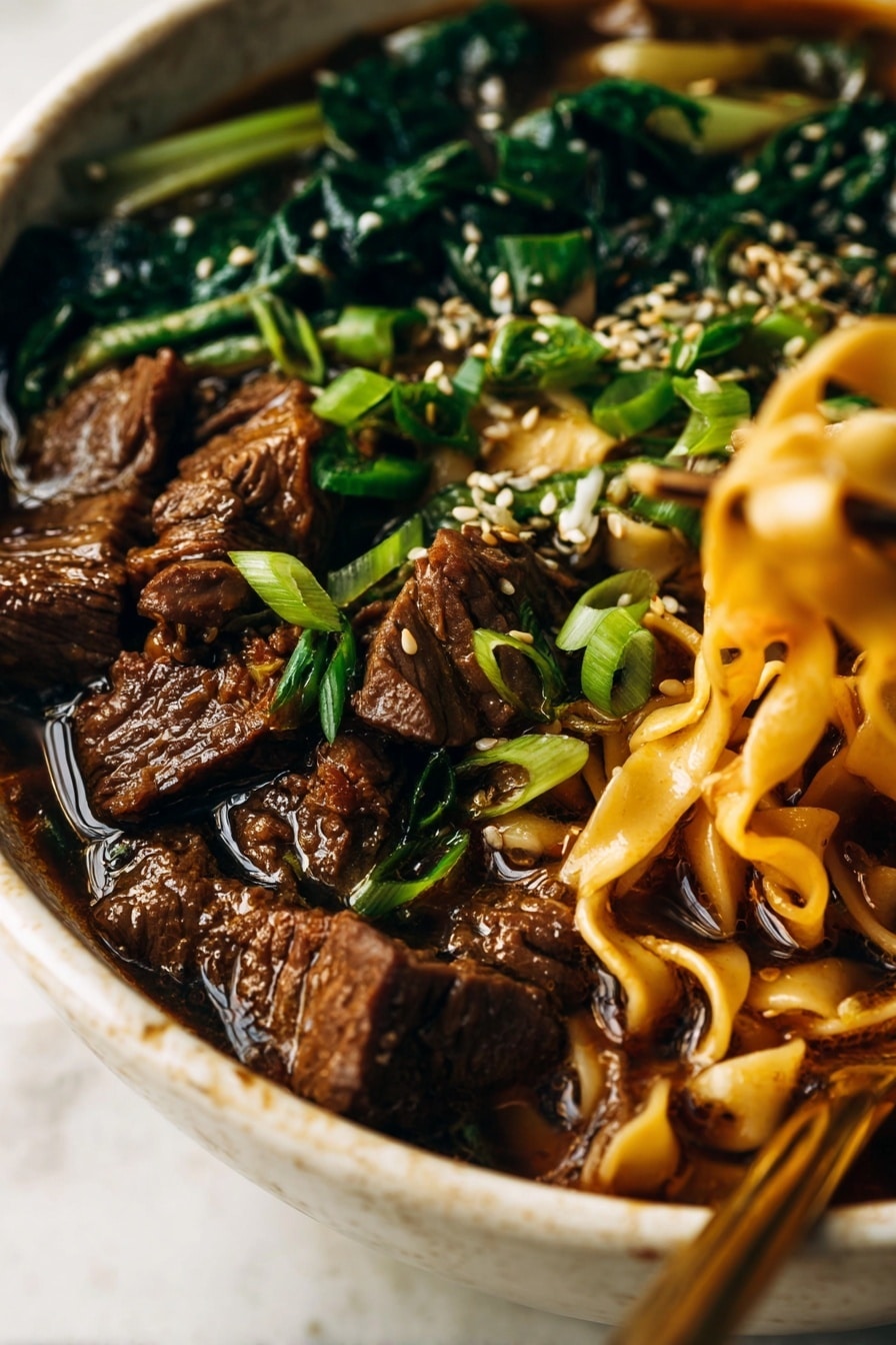 A large speckled bowl filled with wide, flat noodles soaking in dark brown broth forms the bottom layer. On top, there are bright green cooked spinach leaves clustered on one side, contrasting with a pile of tender, dark brown beef chunks on the other side. Scattered over the beef and spinach are white sesame seeds and chopped fresh green onions, adding texture and small pops of color. A white and gold chopstick is held by a woman's hand, gently lifting some noodles on the right side. The bowl sits on a white marbled surface with two seasoning jars blurred in the background. Photo taken with an iphone --ar 2:3 --v 7 - Spicy Short Rib Noodle Soup, Asian-inspired short rib soup, spicy beef noodle soup, quick short rib broth, comforting spicy ramen