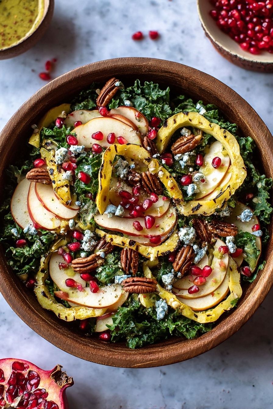 A white bowl sits on a white marbled surface filled with a layered salad. The bottom layer is fresh green kale and spinach leaves, creating a leafy base. On top, there are thin slices of golden yellow squash rings placed evenly around the bowl. Thin slices of light beige apple with red edges lay on the greens, scattered across. Small clusters of white cheese crumbles are spread throughout the salad. Bright red pomegranate seeds and small brown pecan halves are sprinkled on the top, adding texture and color contrast. Nearby are halves of a pomegranate and a small glass jar with golden dressing. Photo taken with an iphone --ar 2:3 --v 7 - Thanksgiving Kale Salad with Cranberry Cinnamon Vinaigrette, holiday kale salad, festive fall salad recipe, healthier Thanksgiving side dish, cranberry cinnamon vinaigrette