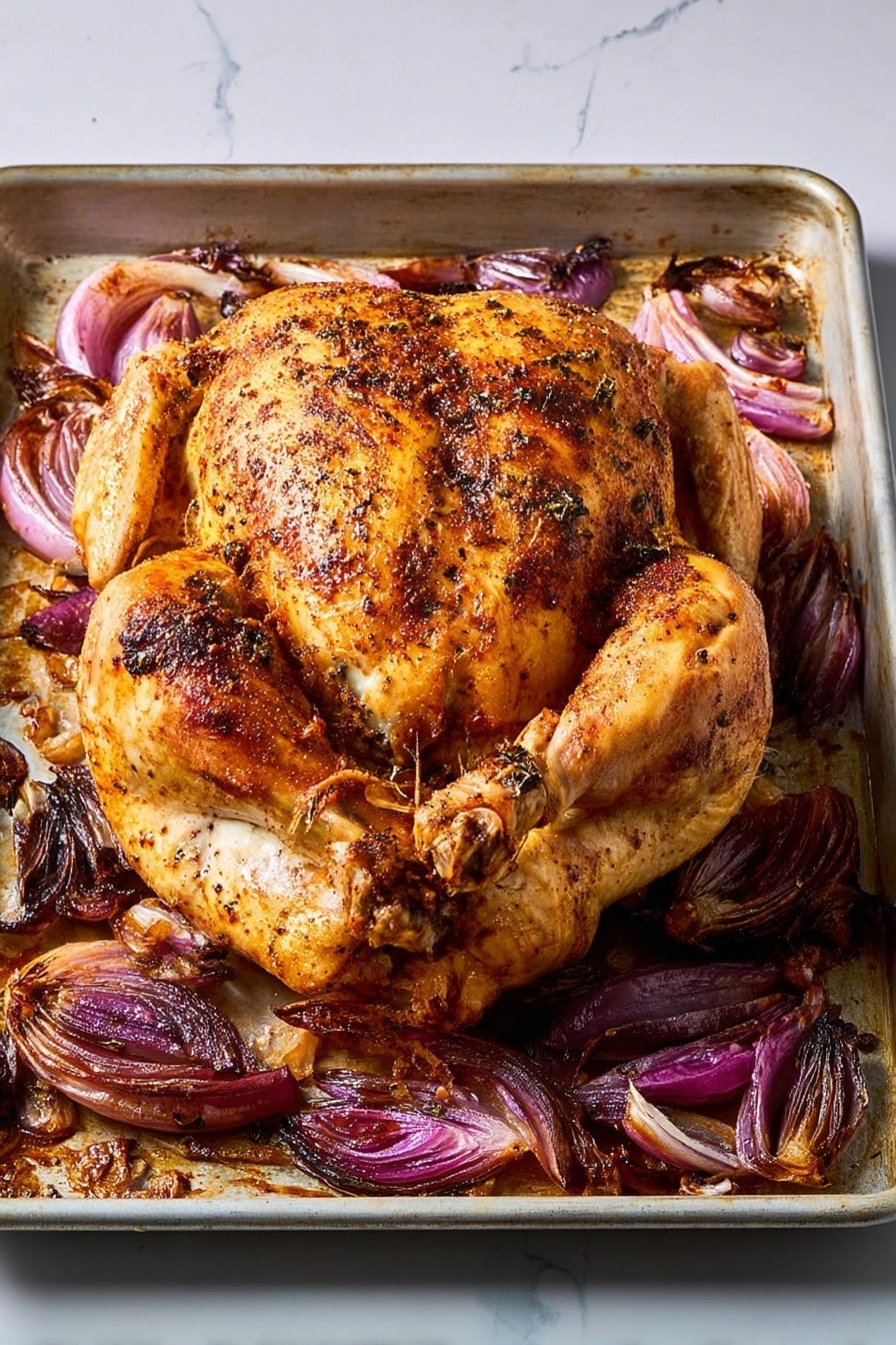 A metal baking tray filled with eight pieces of cooked chicken, ranging in color from golden brown to darker brown with crisp skin, arranged across the tray. Between the chicken pieces are dark purple roasted onion wedges, some slightly charred with caramelized edges, all sitting in a layer of golden cooking juices and small bits of herbs sprinkled sparsely over the top. The surface under the tray is white marbled texture. photo taken with an iphone --ar 2:3 --v 7 - Sheet Pan Red Onion Chicken, easy sheet pan dinner, roasted chicken with red onions, weeknight chicken recipe, simple chicken supper