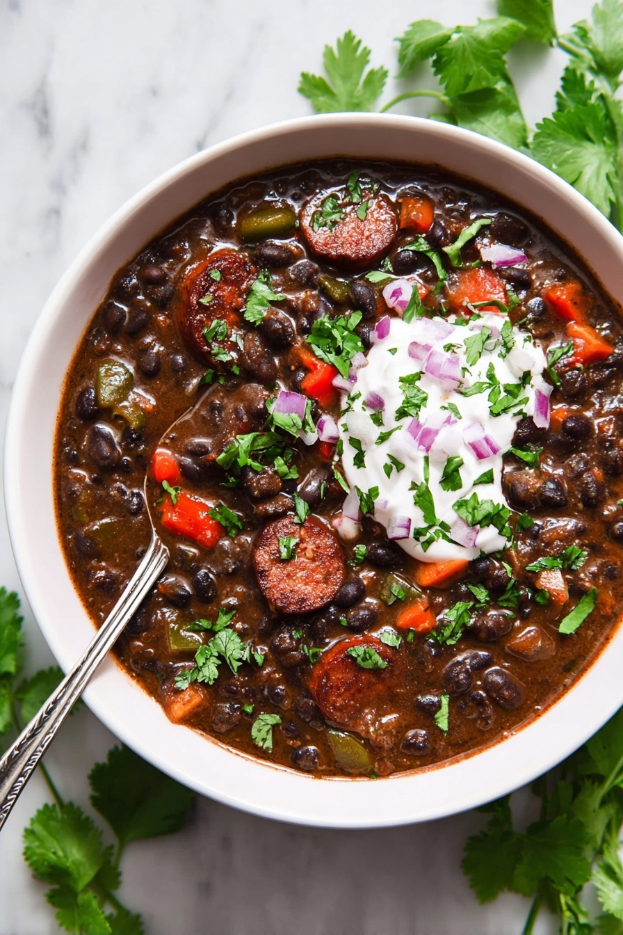The image shows a black pot filled with a thick stew that has a dark brown base. The stew contains black beans, small red and green bell pepper pieces scattered throughout, and thick slices of browned sausage on top, adding a darker, slightly crispy texture. The pot has two handles and is placed on a white marbled surface, highlighting the rich colors inside. The surface of the stew looks smooth and hearty with visible chunks of vegetables and sausage, creating a visually appealing contrast. photo taken with an iphone --ar 2:3 --v 7 - Black Bean Soup with Smoked Sausage and Chili Spices, hearty black bean soup recipe, smoky sausage soup, spicy bean soup, easy make-ahead soup