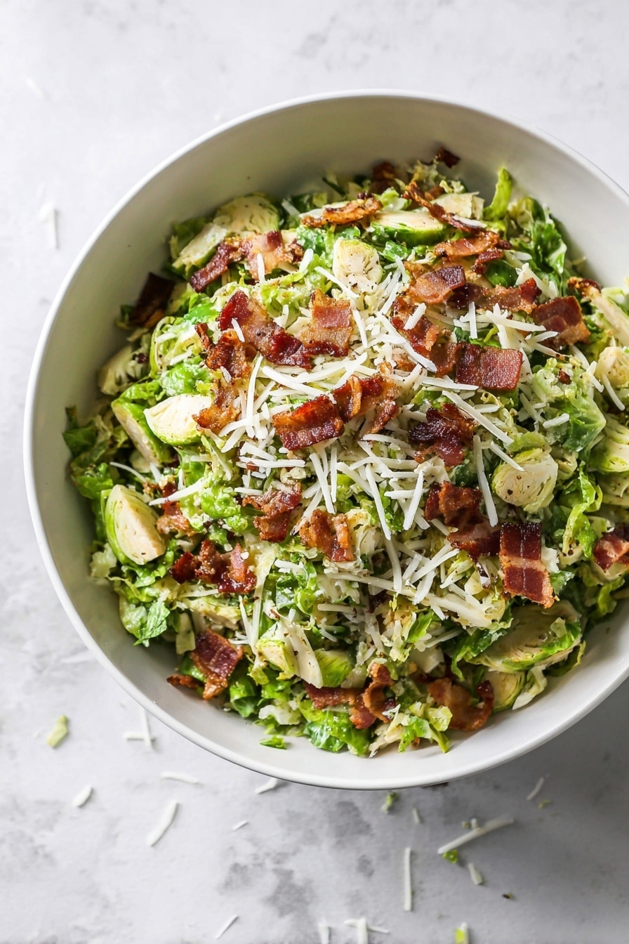 A white bowl filled with chopped Brussels sprouts as the bottom layer, showing bright green and pale green leaves with a slightly rough texture. On top, scattered pieces of crispy, browned bacon are layered unevenly, adding a rich reddish-brown color contrast. Shredded white cheese is sprinkled over the bacon and sprouts, creating a light, flaky layer. The dish is placed on a white marbled surface that adds subtle texture in the background. photo taken with an iphone --ar 2:3 --v 7 - Shredded Brussels Sprouts Salad with Bacon and Asiago, Brussels Sprouts Salad with Bacon and Asiago, Easy Brussels Sprouts Salad, Bacon and Asiago Brussels Sprouts, Healthy Brussels Sprouts Salad