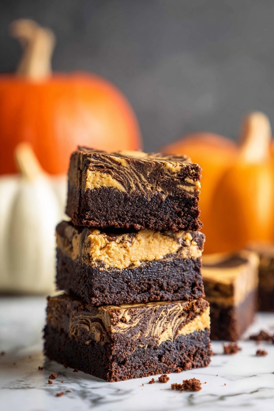 The image shows two square dessert bars with two distinct layers. The bottom layer is dark brown with a dense chocolate texture. The top layer is light tan with dark brown swirls running through it, giving a marbled look. There are small chocolate shavings scattered on the light tan top layer. One bar is placed flat on a white marbled surface, while the other bar is held upright by a woman's hand above the surface, showing the layers clearly. Photo taken with an iphone --ar 2:3 --v 7 - Pumpkin Fudge Brownies, pumpkin fudge brownies recipe, fall brownies with pumpkin, chocolate pumpkin brownies, easy pumpkin dessert