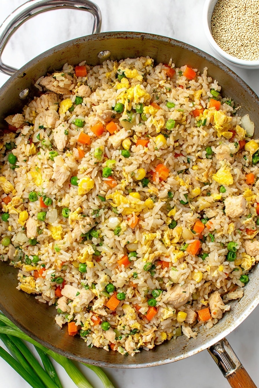 A white bowl filled with fried rice sits on a round wooden tray, placed on a white marbled surface. The fried rice has three visible layers: the base is light brown cooked rice mixed with small pieces of orange carrots, yellow corn kernels, and green peas. The middle layer shows small chunks of light brown chicken and scrambled egg pieces adding yellow tones. The top layer is garnished with bright green chopped scallions and sprinkled sesame seeds. Nearby, a white bowl filled with sesame seeds, a white cup with beige liquid, three whole scallions, and a folded dusty pink cloth with a fork and spoon rest on the marble surface. photo taken with an iphone --ar 2:3 --v 7 - Leftover Turkey Fried Rice, easy turkey fried rice recipe, quick weeknight dinner, holiday leftovers ideas, flavorful fried rice with turkey
