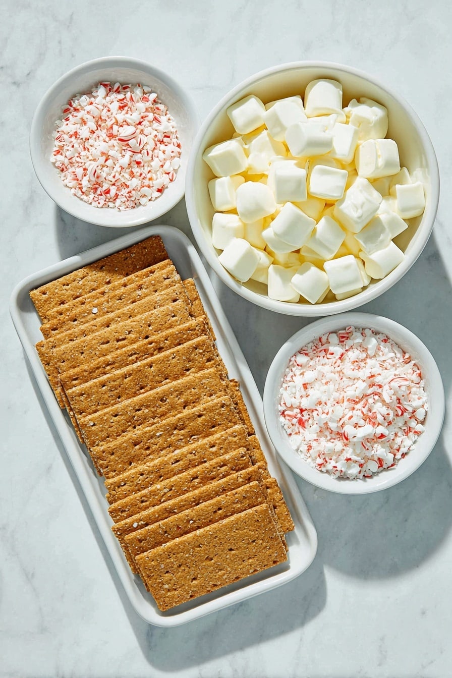 Flat lay of whole unbroken graham crackers arranged in a neat row, a small white ceramic bowl filled with smooth white chocolate melting wafers, a small white ceramic bowl holding finely crushed red and white peppermint pieces, placed on a clean white marble surface, soft natural light, photo taken with an iPhone, professional food photography style, fresh ingredients, white ceramic bowls, no bottles, no duplicates, no utensils, no packaging --ar 2:3 --v 7 --p awthu7i m7354615311229779997 - Peppermint Crunch White Chocolate Covered Graham Crackers, peppermint graham cracker treats, white chocolate peppermint snacks, holiday peppermint desserts, easy peppermint candy