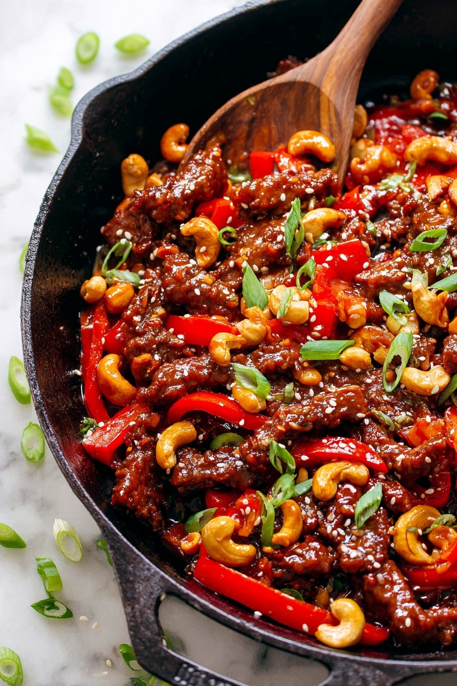 A close-up of a cast iron pan filled with a stir-fry dish featuring three main layers: the first layer consists of glossy, dark brown cooked meat strips with a slightly crispy texture, the second layer shows vibrant red bell pepper strips scattered evenly among the meat, and the third layer includes light golden cashews toasted with a slight char. Green onion slices and small white sesame seeds are sprinkled on top as garnish, adding bright green and white accents. A wooden spoon is partially submerged on the left side of the pan, mixing the ingredients. The pan sits on a white marbled surface with some scattered green onion pieces nearby. Photo taken with an iphone --ar 2:3 --v 7 - Dragon Chicken Stir Fry, spicy chicken stir fry recipe, quick Chinese stir fry, flavorful stir fry dishes, easy chicken stir fry