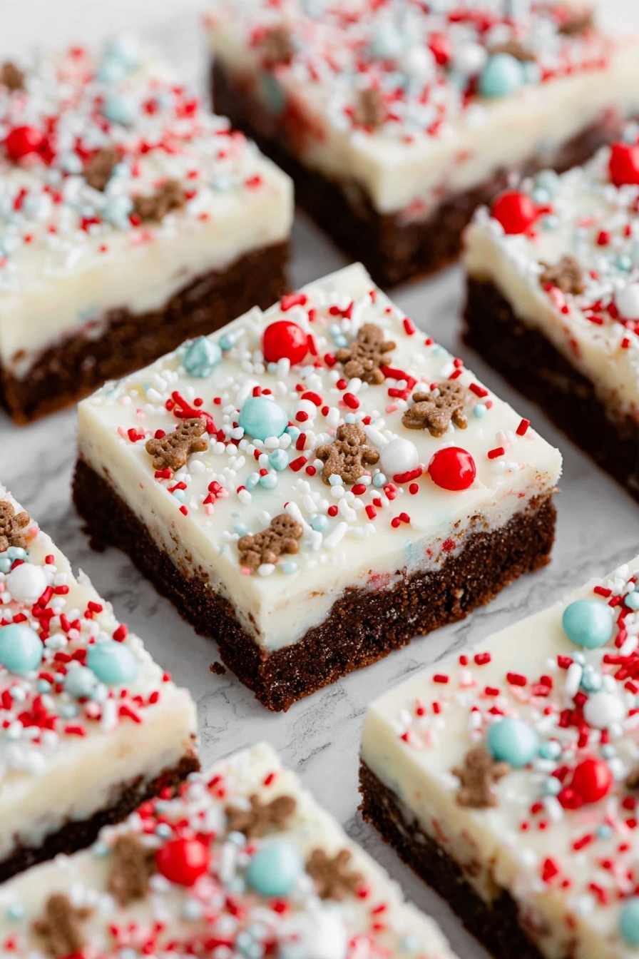 A close-up of a square dessert bar on a white round plate placed on a white marbled surface with a red cloth nearby. The dessert has two layers: a thick, dense brown base with a slightly textured surface, and a thick, fluffy white layer of frosting on top. The frosting is decorated with small, colorful sprinkles in red, white, blue, and brown, including tiny round balls, thin rod-shaped sprinkles, and little gingerbread-shaped pieces. More sprinkles are scattered around the plate and on the surface nearby. In the background, a white plate holds several more pieces of the same dessert. Photo taken with an iphone --ar 2:3 --v 7 - Gingerbread Cookie Bars with Cream Cheese Frosting, gingerbread bars, holiday dessert recipes, spicy gingerbread treats, easy festive cookie bars