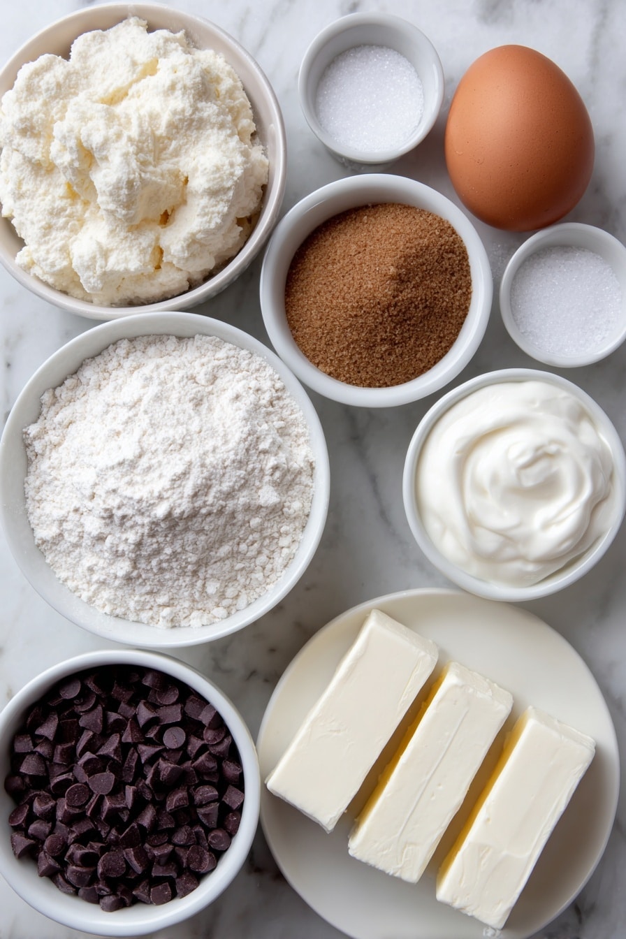 Flat lay of a small mound of softened unsalted butter on a simple white ceramic plate, a small white bowl filled with all-purpose flour, a few scattered grains of kosher salt beside it, a small white bowl holding fine baking soda, a small white bowl with packed dark brown sugar, another small white bowl with granulated sugar, one large whole egg with a clean shell, a small white bowl with golden vanilla extract, semisweet chocolate chips in a simple white ceramic dish, two blocks of soft cream cheese on a plain white plate, a small white bowl filled with sour cream, placed on a clean white marble surface, soft natural light, photo taken with an iPhone, professional food photography style, fresh ingredients, white ceramic bowls, no bottles, no duplicates, no utensils, no packaging --ar 2:3 --v 7 --p m7354615311229779997 - Cookie Dough Cheesecake Bars, Cookie Dough Cheesecake Bars recipe, Easy Cookie Dough Cheesecake Bars, No-Bake Cookie Dough Cheesecake Bars, Delicious Cookie Dough Cheesecake Bars