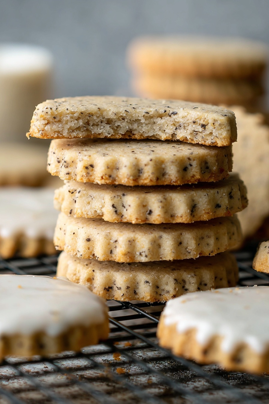 A stack of five round cookies with scalloped edges and a light beige color speckled with small dark bits is shown. The top cookie is broken in half, revealing a soft and crumbly texture inside. Around the stack are more cookies, some whole and some dipped halfway in white icing. The cookies rest on a black wire rack with a white marbled texture background softly blurred. The lighting is natural, highlighting the cookie details clearly. Photo taken with an iphone --ar 2:3 --v 7 - Chai Shortbread Cookies, spicy shortbread cookies, chai spice recipes, easy shortbread cookies, cozy holiday treats