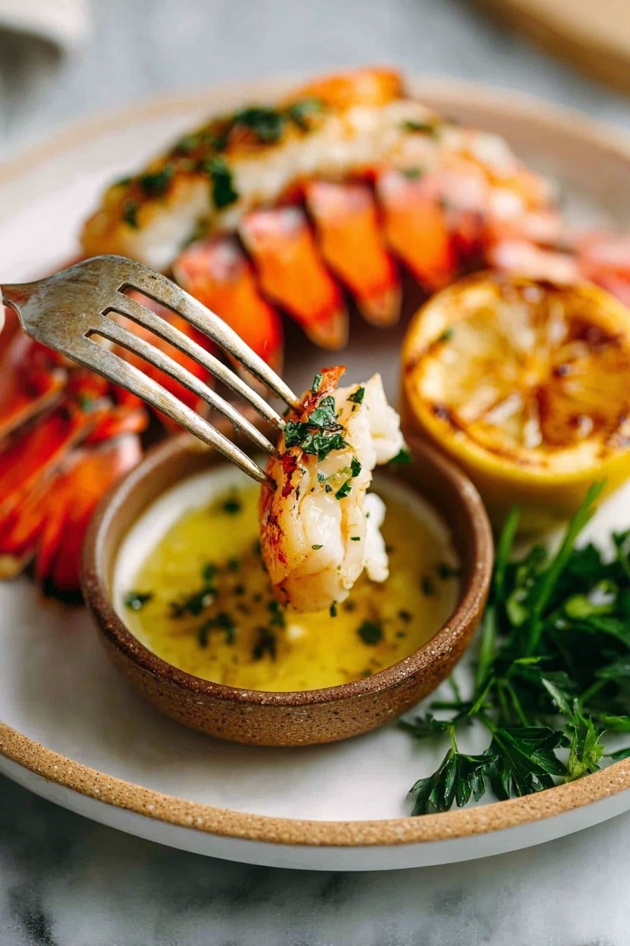 The dish shows a cooked lobster tail placed in the center of a shallow white plate. The lobster tail has two main visible layers: the outer shell is a bright red-orange with small white spots, and the inner meat is a creamy white with a golden brown, slightly crispy top layer seasoned with green herbs. Behind the lobster tail, there are two thick lemon slices with charred marks, adding a yellow color with black spots. On the plate's side, there is a small white bowl filled with a green dipping sauce. Some vibrant green parsley is placed around the lemon slices. The whole scene rests on a white marbled surface. Photo taken with an iphone --ar 2:3 --v 7 - Perfect Garlic Butter Lobster Tails, lobster tail recipes, easy seafood dinner, garlic butter lobster, gourmet lobster meal