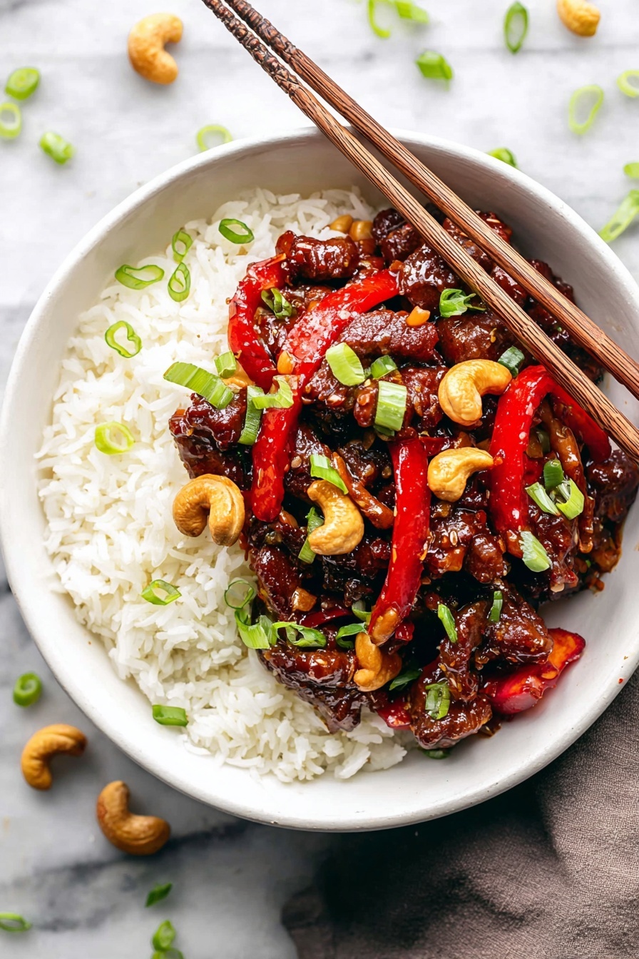 A bowl with a bottom layer of white cooked rice topped with a generous layer of dark brown glazed pieces of meat, mixed with light brown roasted cashew nuts and bright red slices of bell pepper. Scattered on top are small green onion pieces adding a fresh contrast. The bowl is white and rests on a white marbled surface, with a pair of light wooden chopsticks placed across the bowl's edge. The textures show sticky sauce covering the meat and nuts, and the colors are rich and vibrant, making the dish look fresh and tasty. photo taken with an iphone --ar 2:3 --v 7 - Dragon Chicken Stir Fry, spicy chicken stir fry recipe, quick Chinese stir fry, flavorful stir fry dishes, easy chicken stir fry