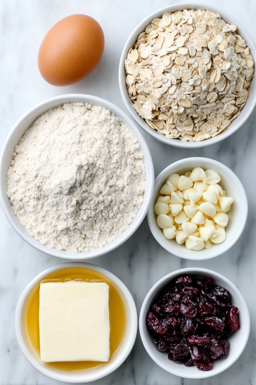 Flat lay of a small mound of light brown oatmeal cookie mix powder next to a small pile of old-fashioned rolled oats, a small white ceramic bowl filled with melted golden unsalted butter, one large uncracked brown egg, a small white ceramic bowl with creamy 2% milk, a small white ceramic bowl holding clear pale vanilla extract, a small heap of bright red dried cranberries, and a small mound of creamy white chocolate chips arranged symmetrically in a circular pattern, all placed on a clean white marble surface, soft natural light, photo taken with an iPhone, professional food photography style, fresh ingredients, white ceramic bowls, no bottles, no duplicates, no utensils, no packaging --ar 2:3 --v 7 --p m7354615311229779997 - White Chocolate Cranberry Oatmeal Cookies, cranberry oatmeal cookies, white chocolate cookies, easy holiday cookies, chewy oatmeal cookies