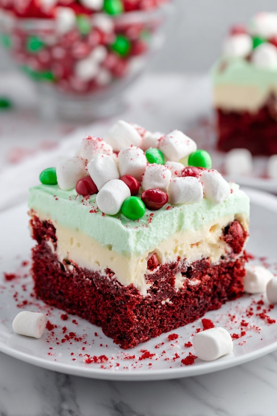 The image shows a glass square dish with a festive layered dessert. The bottom layer is dark red, soft and moist, like cake. On top of that is a thick pale green creamy layer. The topmost layer is fully covered with small white marshmallows, red and green round candies, and thin red sprinkles scattered across. A woman's hand holding a wooden spatula is lifting one square piece of the dessert, showing the layers clearly. The dish is placed on a white marbled surface with a black and white checkered cloth under one side, and a white plate with a slice of the dessert in the background. The scene is bright and clean. photo taken with an iphone --ar 2:3 --v 7 - Red Velvet Poke Cake with Cheesecake Fluff, Festive Red Velvet Cake, Cheesecake Fluff Dessert, Holiday Poke Cake, Easy Red Velvet Cake Recipe