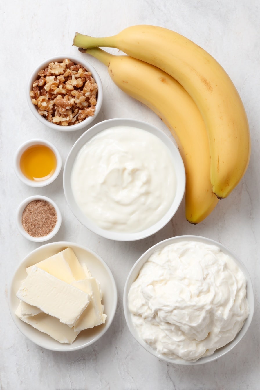 Flat lay of two fresh whole bananas, a small pile of roughly crushed golden vanilla wafers, a simple white ceramic bowl filled with smooth sweetened condensed milk, a small white bowl containing a block of soft cream cheese, a tiny white bowl holding golden vanilla extract, a tiny white bowl with fine sea salt crystals, a tiny white bowl with ground nutmeg powder, and a white ceramic bowl filled with thick, fluffy heavy cream, all arranged in perfect symmetry on a clean white marble surface, soft natural light, photo taken with an iPhone, professional food photography style, fresh ingredients, white ceramic bowls, no bottles, no duplicates, no utensils, no packaging --ar 2:3 --v 7 --p m7354615311229779997 - No-Churn Banana Pudding Ice Cream, banana pudding ice cream, easy no-churn ice cream recipe, homemade banana ice cream, no-ice-cream maker desserts