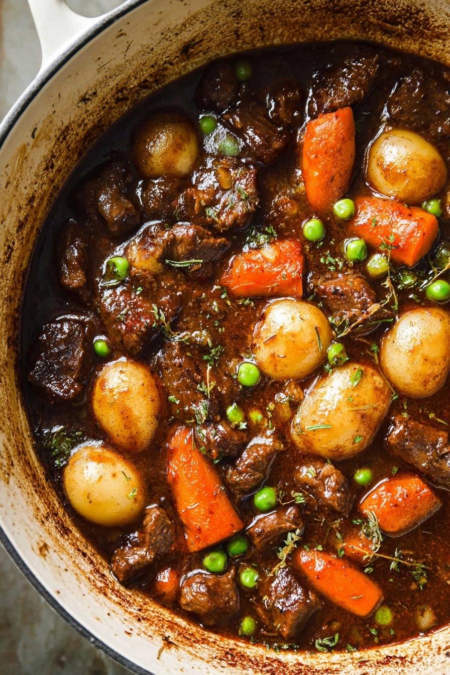 Two bowls of beef stew sit on a white marbled surface, filled with layered chunks of brown beef, bright orange carrots, yellow potatoes, and green peas, all coated in a rich, thick brown sauce. The first bowl is in focus, showing a gold spoon lifting a scoop that contains pieces of tender beef, a carrot, and peas, garnished with small green herbs. The second bowl blurs softly in the background, echoing the hearty mix. Both bowls are white with a subtle gray speckled pattern. Soft natural light highlights the glossy textures of the stew and the fresh ingredients, photo taken with an iphone --ar 2:3 --v 7 - Hearty Lamb Stew with Potatoes and Carrots, lamb stew recipe, comforting lamb stew, easy lamb stew, savory beef and vegetable stew